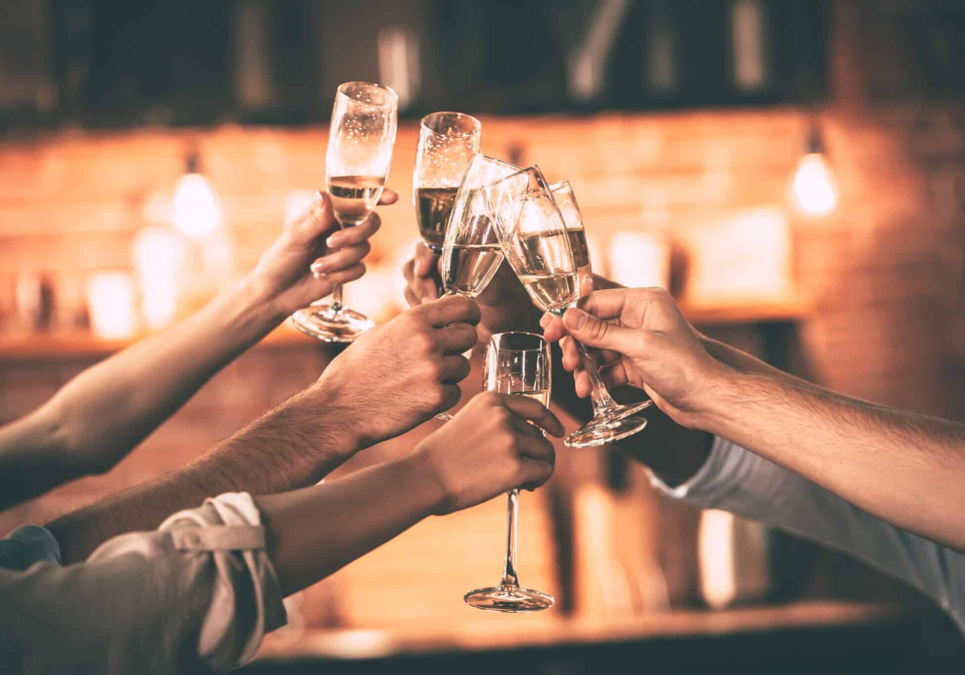 Cheers!,Group,Of,People,Cheering,With,Champagne,Flutes,With,Home